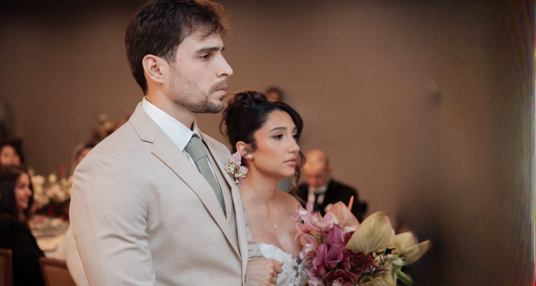 Bride and groom side by side during an indoor ceremony